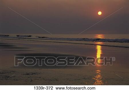 Stock Image - Sunset over the ocean. Fotosearch