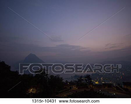 Switzerland, Ticino, Lugano, Lake Lugano, landscape at dusk View Large Photo Image Stock Image - Switzerland, Ticino, Lugano, Lake Lugano, landscape at dusk. Fotosearch