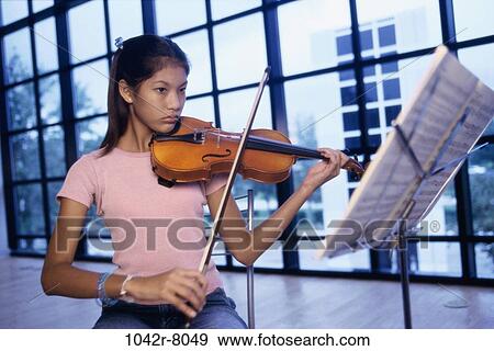 Stock Photo - Teenage girl playing the violin. Fotosearch