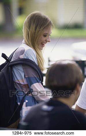 Stock Photography - Teenage girl smiling near a teenage boy. Fotosearch