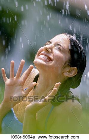 Teenage girl standing in the rain View Large Photo Image Stock Image - Teenage girl standing in the rain. Fotosearch