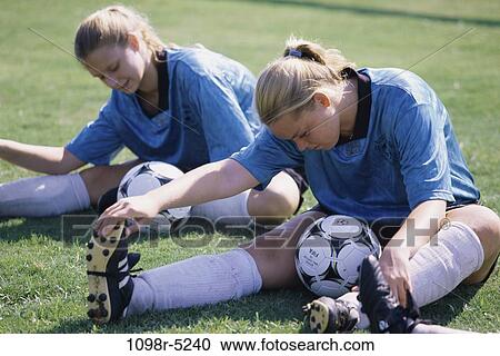 Teenage girls in soccer uniforms doing stretching exercises View Large Photo Image Stock Image - Teenage girls in soccer uniforms doing stretching exercises. Fotosearch