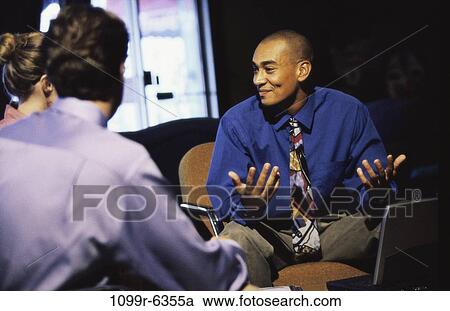 Stock Image - Three business executives in a meeting. Fotosearch