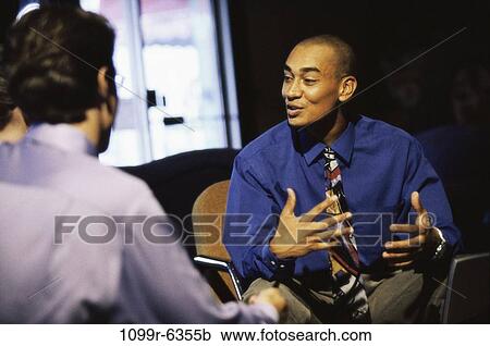 Stock Image - Three business executives in a meeting. Fotosearch