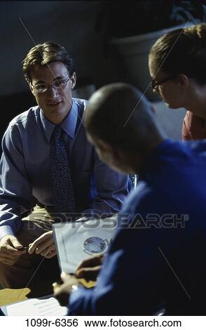 Stock Photograph - Three business executives in a meeting. Fotosearch