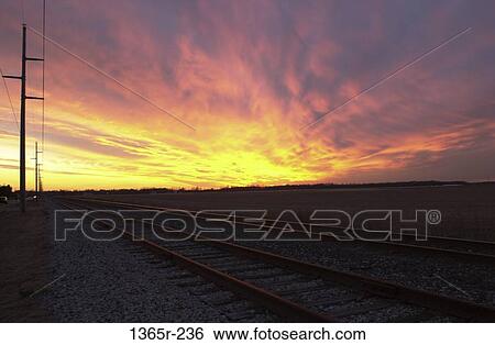 Stock Photograph - Train tracks at sunset. Fotosearch