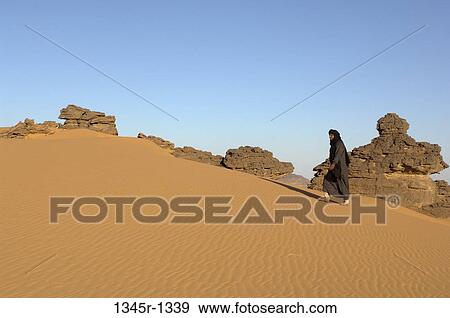 Tuareg man walking in a desert, Tadrart Acacus, Fezzan, Libya View Large Photo Image Stock Photo - Tuareg man walking in a desert, Tadrart Acacus, Fezzan, Libya. Fotosearch