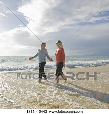 Tunisia, Couple walking along beach View Large Photo Image Stock Image - Tunisia, Couple walking along beach. Fotosearch