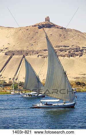 Two feluccas sail up the Nile River at Aswan, Egypt View Large Photo Image Stock Image - Two feluccas sail up the Nile River at Aswan, Egypt. Fotosearch