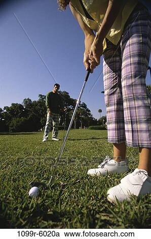 Stock Image - Two people playing golf. Fotosearch