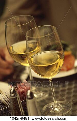 Stock Image - Two wineglasses on a table. Fotosearch