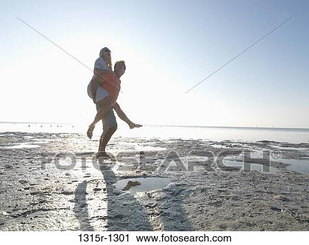 USA, Florida Keys, Islamorada, couple piggy backing US on beach View Large Photo Image Stock Image - USA, Florida Keys, Islamorada, couple piggy backing US on beach. Fotosearch
