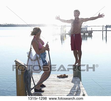 USA, Florida Keys, Islamorada, couple playing with water spray on pier View Large Photo Image Stock Photo - USA, Florida Keys, Islamorada, couple playing with water spray on pier. Fotosearch