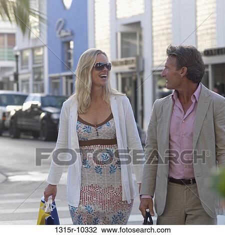 Stock Image - USA, Florida, Miami Beach, Couple shopping in art deco district. Fotosearch