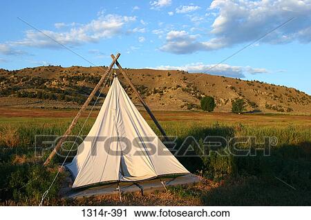 USA, Wyoming, Cody, Teepee in plains next to mountains View Large Photo Image Stock Image - USA, Wyoming, Cody, Teepee in plains next to mountains. Fotosearch