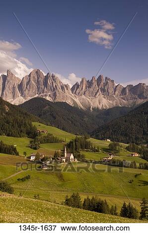 Stock Photo - Village with mountain range on a landscape, Santa Maddalena, Funes Valley, Dolomites, Trentino-Alto-Adige, Italy. Fotosearch