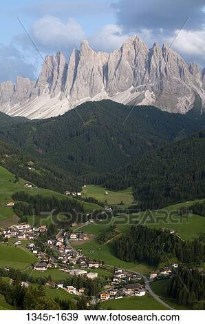 Stock Photo - Village with mountain range on a landscape, Santa Maddalena, Funes Valley, Dolomites, Trentino-Alto-Adige, Italy. Fotosearch