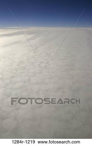White clouds in a blue sky View Large Photo Image Stock Photo - White clouds in a blue sky. Fotosearch