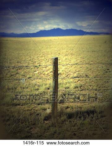 Wire fence in a field View Large Photo Image Stock Photography - Wire fence in a field. Fotosearch