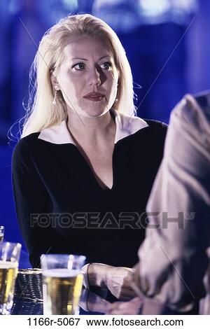 Woman at a bar View Large Photo Image Stock Photo - Woman at a bar. Fotosearch