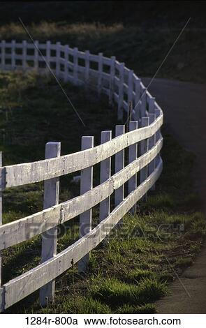 Stock Image - Wooden fence alongside a road. Fotosearch