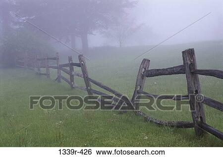 Wooden fence in a field View Large Photo Image Stock Photograph - Wooden fence in a field. Fotosearch