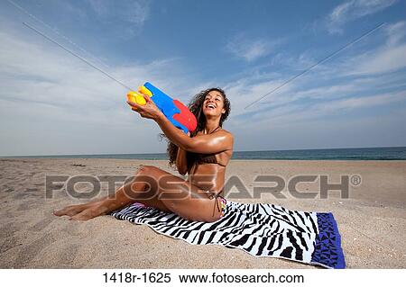 Young Brunette Woman at the beach enjoying herself View Large Photo Image Stock Photography - Young Brunette Woman at the beach enjoying herself. Fotosearch