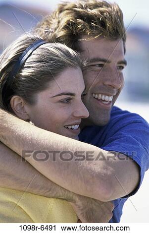 Stock Image - Young couple hugging each other. Fotosearch