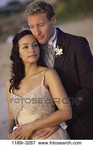 Stock Photo - Young couple hugging each other. Fotosearch