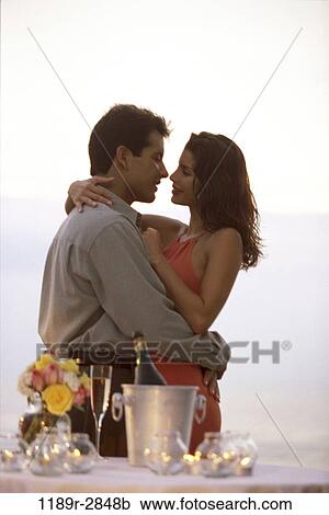 Stock Image - Young couple hugging on the beach. Fotosearch