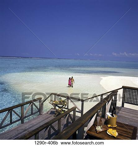 Stock Image - Young couple hugging on the beach, Maldives. Fotosearch
