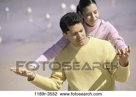 Stock Image - Young couple on the beach. Fotosearch