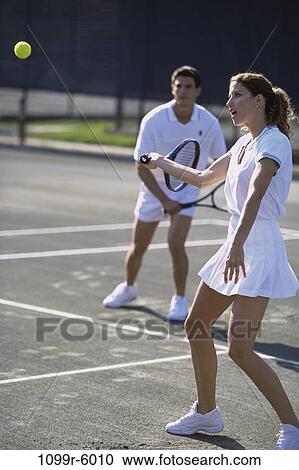 Young couple playing tennis View Large Photo Image Stock Image - Young couple playing tennis. Fotosearch