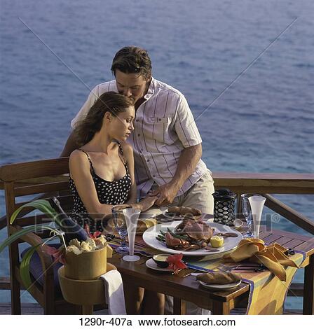 Young couple sitting together at a table, Maldives View Large Photo Image Stock Image - Young couple sitting together at a table, Maldives. Fotosearch