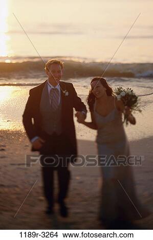 Young couple walking on the beach View Large Photo Image Picture - Young couple walking on the beach. Fotosearch