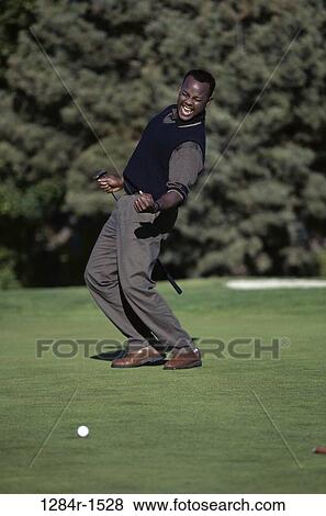 Young man celebrating on a golf course View Large Photo Image Stock Photo - Young man celebrating on a golf course. Fotosearch