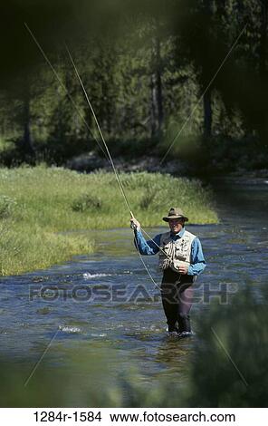 Young man fishing, Stanley, Idaho, USA View Large Photo Image Picture - Young man fishing, Stanley, Idaho, USA. Fotosearch