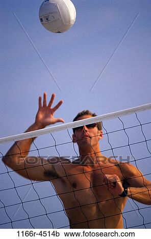 Young man playing beach volleyball View Large Photo Image Stock Image - Young man playing beach volleyball. Fotosearch