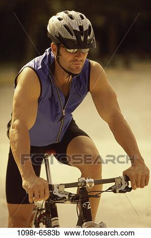 Young man sitting on a bicycle View Large Photo Image Stock Image - Young man sitting on a bicycle. Fotosearch