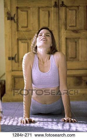 Young woman exercising on the floor View Large Photo Image Stock Image - Young woman exercising on the floor. Fotosearch