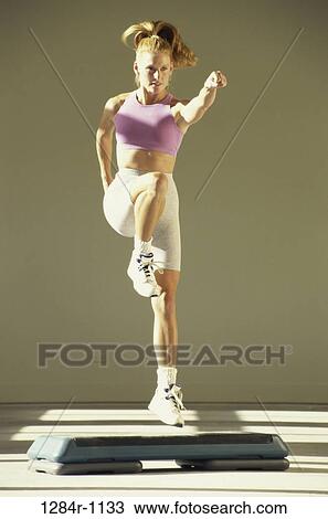 Young woman exercising View Large Photo Image Stock Image - Young woman exercising. Fotosearch