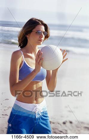 Young woman holding a volleyball View Large Photo Image Stock Photo - Young woman holding a volleyball. Fotosearch
