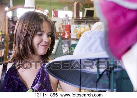 Young woman shopping in a store View Large Photo Image Stock Photography - Young woman shopping in a store. Fotosearch