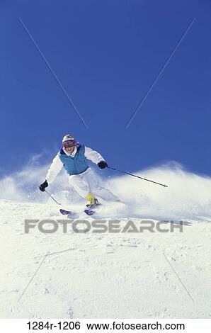 Stock Photograph - Young woman skiing, Bald Mountain, Sun Valley, Idaho, USA. Fotosearch