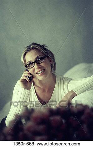 Stock Photo - Young woman talking on a mobile phone. Fotosearch