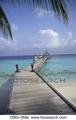 Young woman walking on a pier, Maldives View Large Photo Image Stock Image - Young woman walking on a pier, Maldives. Fotosearch