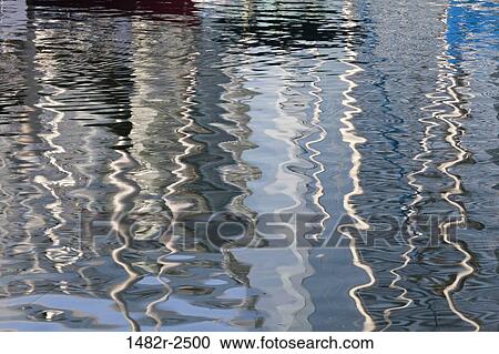 Stock Image - Abstract reflections of sailboats in water, Seaport Village, San Diego, California, USA. Fotosearch