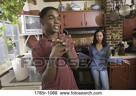 Stock Photo - African American brother and sister in kitchen. Fotosearch