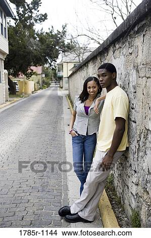 African American teenagers leaning against wall outside View Large Photo Image Picture - African American teenagers leaning against wall outside. Fotosearch