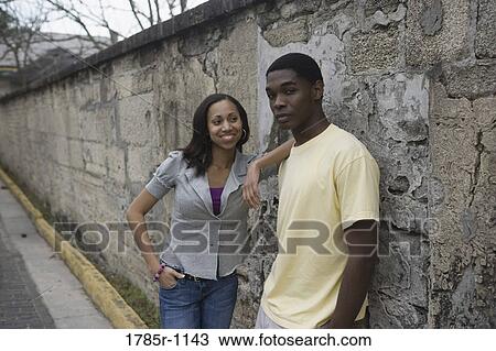 African American teenagers leaning against wall outside View Large Photo Image Stock Image - African American teenagers leaning against wall outside. Fotosearch